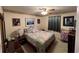 Comfortable bedroom with a ceiling fan, patterned bedding, and ample closet space at 310 Creekside Trl, Covington, GA 30016