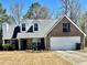 Charming brick home featuring a two-car garage, dormer windows, and a well-maintained front yard at 310 Creekside Trl, Covington, GA 30016