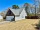 Home's garage exterior with vinyl siding and a fenced in back yard at 310 Creekside Trl, Covington, GA 30016