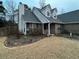 Well landscaped front entrance with mature shrubs and brick detailing at 310 Creekside Trl, Covington, GA 30016