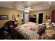 Main bedroom with patterned bedding, a ceiling fan, and dark hardwood floors at 310 Creekside Trl, Covington, GA 30016