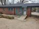 Brick home's backyard with a concrete ramp leading to the back door and a convenient carport at 3112 Cloverhurst Dr, Atlanta, GA 30344