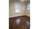 Bedroom featuring hardwood flooring and two windows that allow ample natural light at 3112 Cloverhurst Dr, Atlanta, GA 30344