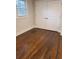 Cozy bedroom with hardwood floors, natural light from the window, and white closet doors at 3112 Cloverhurst Dr, Atlanta, GA 30344