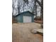 Detached garage with a modern white door, set against a backdrop of bare trees at 3112 Cloverhurst Dr, Atlanta, GA 30344