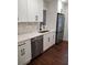 Beautiful kitchen with white cabinets, stainless steel dishwasher, and quartz countertops at 3112 Cloverhurst Dr, Atlanta, GA 30344