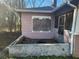 Exterior of home showing boarded-up windows and overgrown yard needing repair at 750 Alta Pl, Atlanta, GA 30318