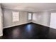 Large bedroom featuring neutral walls, dark hardwood flooring, and ample natural light at 1692 Shirley Sw St, Atlanta, GA 30310