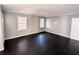 Spacious bedroom featuring neutral gray walls, dark hardwood flooring, and abundant natural light at 1692 Shirley Sw St, Atlanta, GA 30310