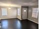 Spacious living room featuring large windows, fresh paint, and a modern chandelier at 1692 Shirley Sw St, Atlanta, GA 30310