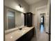 A well-lit bathroom features a granite countertop, dark wood cabinets, and tile floors at 222 Blossom Trl, Acworth, GA 30101