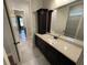 A well-lit bathroom features a granite countertop, dark wood cabinets, and tile floors at 222 Blossom Trl, Acworth, GA 30101