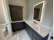 Stylish bathroom featuring a black vanity with marble countertop and a unique LED mirror at 222 Blossom Trl, Acworth, GA 30101