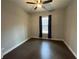 This bedroom features a ceiling fan, a window with curtains, and hardwood floors at 222 Blossom Trl, Acworth, GA 30101