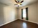 This bedroom features a ceiling fan, a window with curtains, and hardwood floors at 222 Blossom Trl, Acworth, GA 30101