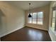 This empty dining area features a large window offering natural light and dark hardwood floors at 222 Blossom Trl, Acworth, GA 30101