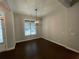 This empty dining area features modern light fixture, a large window, and dark hardwood floors at 222 Blossom Trl, Acworth, GA 30101