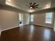 Spacious main bedroom with tray ceilings, hardwood floors, and an open en-suite bathroom at 222 Blossom Trl, Acworth, GA 30101