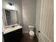 Chic powder room featuring a modern vanity with marble countertop and stylish fixtures at 222 Blossom Trl, Acworth, GA 30101