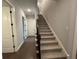 Carpeted staircase with gray walls and white trim at 222 Blossom Trl, Acworth, GA 30101