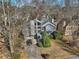 An aerial view of a home with large windows, mature trees and a two car garage at 2541 Deer Isle Cv, Lawrenceville, GA 30044