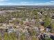 Aerial view of home nestled within a mature wooded neighborhood at 2541 Deer Isle Cv, Lawrenceville, GA 30044