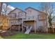 Back view of a two-story home with a well-maintained backyard, deck, and stairs at 2541 Deer Isle Cv, Lawrenceville, GA 30044