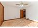 Bedroom featuring a ceiling fan, closet, and entry to another room needing renovation at 2541 Deer Isle Cv, Lawrenceville, GA 30044