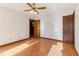 Bedroom with ceiling fan, hardwood floors, and natural light at 2541 Deer Isle Cv, Lawrenceville, GA 30044