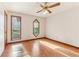 Bright bedroom featuring hardwood floors and unique windows providing natural light at 2541 Deer Isle Cv, Lawrenceville, GA 30044