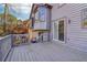 A large gray weathered deck with a gray railing and a sliding glass door at 2541 Deer Isle Cv, Lawrenceville, GA 30044