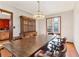 Traditional dining room featuring a wooden table, chairs, and a vintage chandelier at 2541 Deer Isle Cv, Lawrenceville, GA 30044