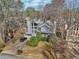 An aerial view of a home with large windows, mature trees and a two car garage at 2541 Deer Isle Cv, Lawrenceville, GA 30044