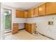 Bright laundry room with counter, cabinets, and a window with natural light at 2541 Deer Isle Cv, Lawrenceville, GA 30044