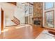 Bright living room with a fireplace, high ceilings, and staircase leading to the loft at 2541 Deer Isle Cv, Lawrenceville, GA 30044