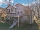 Back of home featuring a multi-level deck, stairs to the backyard, and wooden facade at 2541 Deer Isle Cv, Lawrenceville, GA 30044