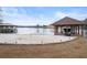 A lakeside backyard featuring a sandy beach with dock and boat storage at 3167 Bay View Dr, Jonesboro, GA 30236