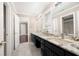 Bathroom featuring double sink vanity with black cabinets and granite countertops and tile floors at 3167 Bay View Dr, Jonesboro, GA 30236