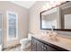 Bathroom with warm neutral paint, marble counters, dark wood cabinets and a vessel sink at 3167 Bay View Dr, Jonesboro, GA 30236