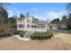 Back exterior of the house, showcasing a spacious deck, steps down to a well-maintained yard, and mature landscaping at 3167 Bay View Dr, Jonesboro, GA 30236