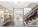 A home foyer with mosaic tile flooring and a modern staircase at 3167 Bay View Dr, Jonesboro, GA 30236