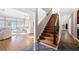 Foyer with hardwood floors, a staircase with black metal railing, and an open view into the living room at 3167 Bay View Dr, Jonesboro, GA 30236