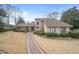 Inviting home exterior featuring stone accents, a brick walkway, and meticulously maintained landscaping at 3167 Bay View Dr, Jonesboro, GA 30236