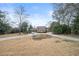 Well-manicured lawn in front of home featuring a circular driveway and mature trees at 3167 Bay View Dr, Jonesboro, GA 30236