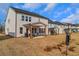 Backyard view showcasing the covered patio and manicured lawn at 335 Tillman Pass, Woodstock, GA 30188