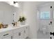 Bright bathroom featuring a white vanity with black hardware and a view to the toilet at 335 Tillman Pass, Woodstock, GA 30188