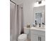 Well-lit bathroom featuring a white vanity with a combined shower and tub at 335 Tillman Pass, Woodstock, GA 30188