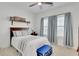 Cozy bedroom featuring neutral walls, carpet, and white bedding, highlighted by natural light from large window at 335 Tillman Pass, Woodstock, GA 30188