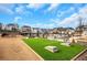 Outdoor recreation area featuring cornhole, benches, and landscaped surroundings at 335 Tillman Pass, Woodstock, GA 30188