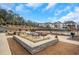 Outdoor community pool area with seating, grills, and lush landscaping on a sunny day at 335 Tillman Pass, Woodstock, GA 30188